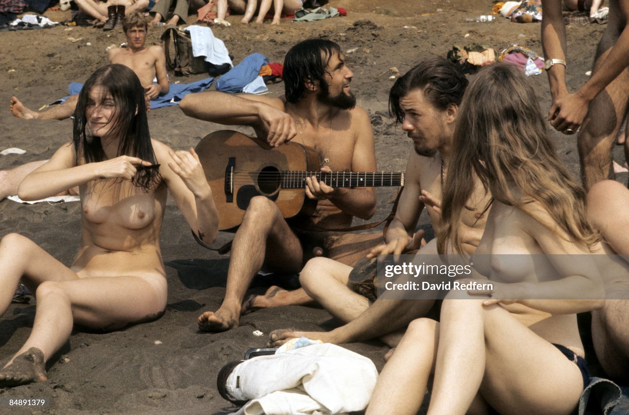 Naked hippies sit on the beach on the Isle of Wight, United Kingdom, during the festival on 01 January 1969. 