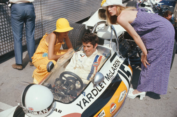 Brian Redman, McLaren M19A Ford, in the pits with fashion models at the 1972 Monaco Grand Prix. 
