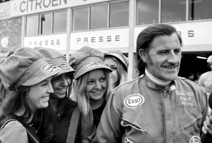 Graham Hill with some girls at the Belgium Grand Prix in Nivelles-Baulers on June 04, 1972.