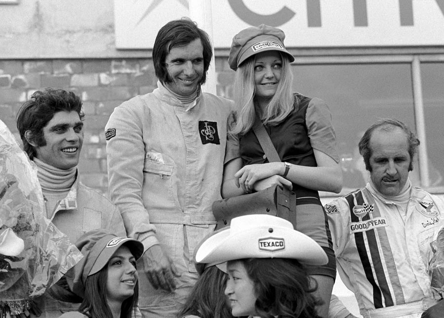 François Cevert, Emerson Fittipaldi and Denny Hulme with some girls at the Belgium Grand Prix in Nivelles-Baulers on June 04, 1972.