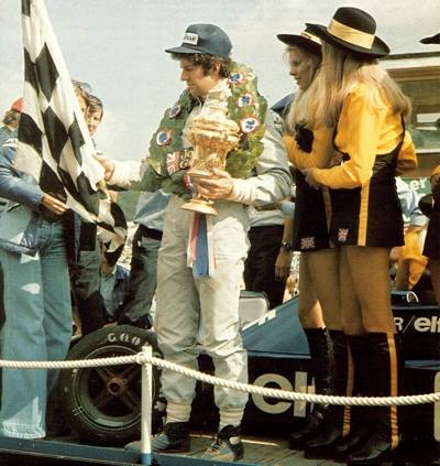 Jody Scheckter on the podium with JPS girls at Brands Hatch on 20 July 1974.