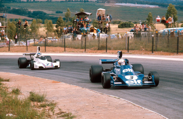 Jody Scheckter, Tyrrell 007 Ford, leads Carlos Reutemann, Brabham BT44B Ford, at the South African Grand Prix in Kyalami on 01 March 1975. 