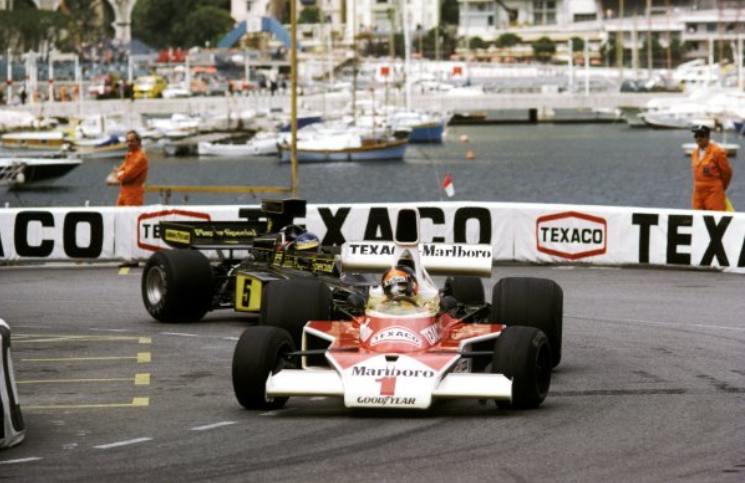 Emerson Fittipaldi, McLaren M23, who climbed from ninth on the grid to finish second, leads Ronnie Peterson, Lotus 72E, who finished fourth, at the Monaco Grand Prix on 11 May 1975. 