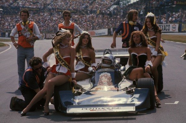 Guy Edwards sits in his Hesketh 308D Ford on the grid surrounded by ladies wearing sashes advertising one of his sponsors at Brands Hatch on 18 July 1976. 