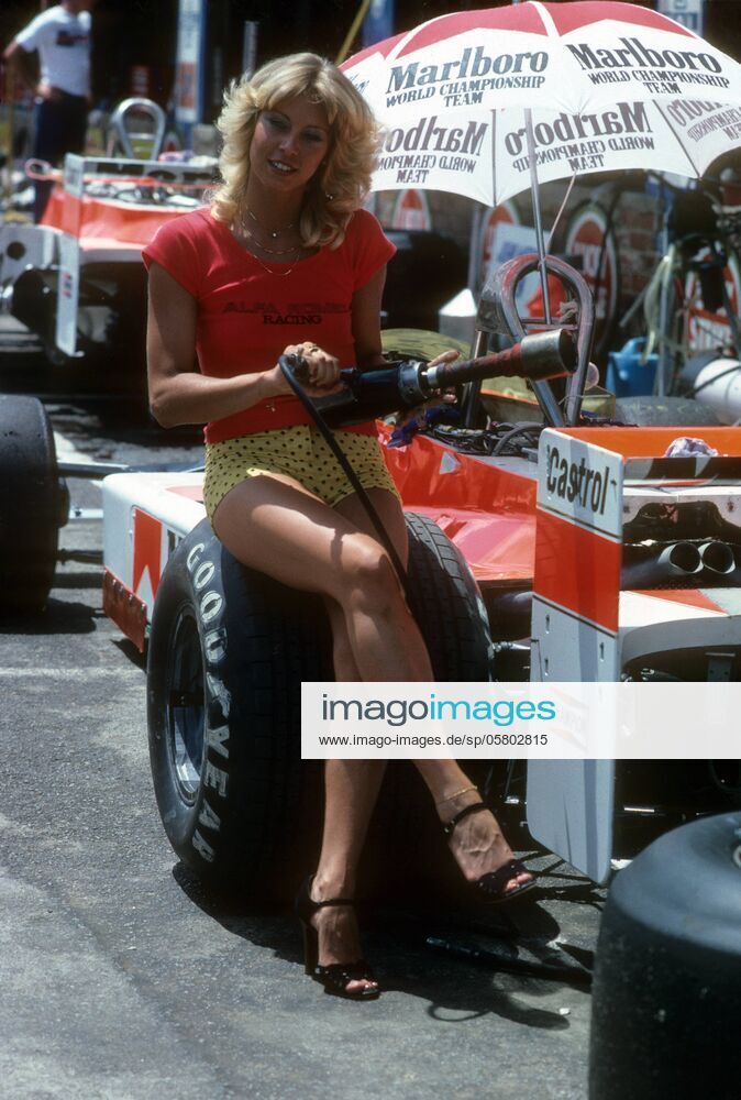 Sexy Alfa Romeo pit girl with an impact wrench on a McLaren Ford at the 1979 South African Grand Prix in Kyalami on 03 March 1979.