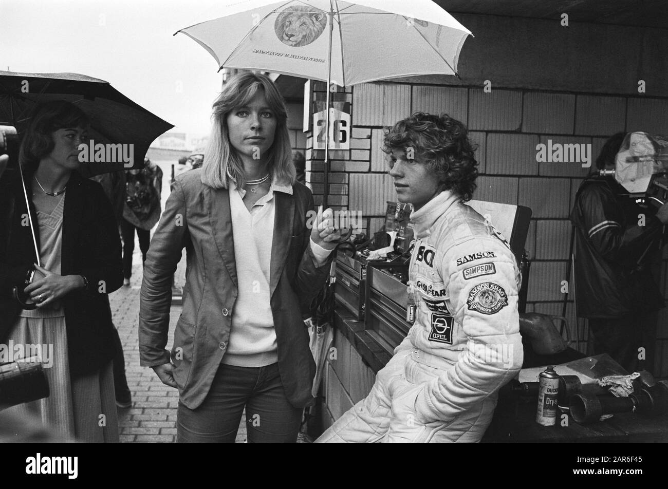 A girl holding umbrella over the head of Jan Lammers at the Dutch Grand Prix in Zandvoort on 24 August 1979.