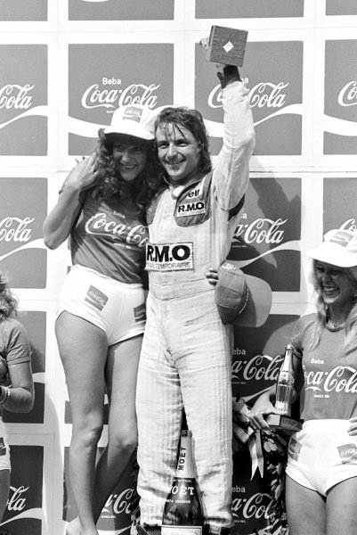 René Arnoux, Renault, celebrates his first Grand Prix victory on the podium with a Coca Cola girl at the Brazilian Grand Prix in Interlagos on 27 January 1980.