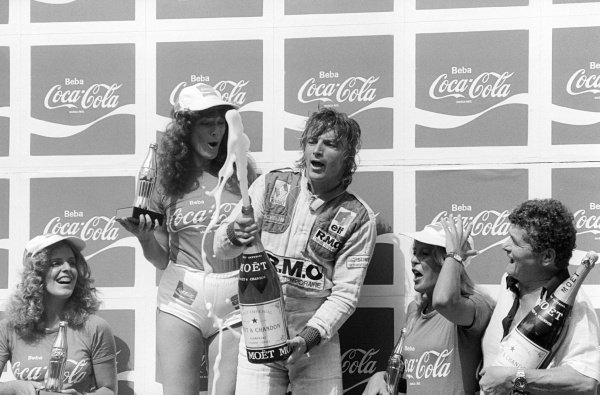 René Arnoux, Renault, celebrates his first Grand Prix victory on the podium with Coca Cola girls at the Brazilian Grand Prix in Interlagos on 27 January 1980.