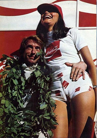 Jacques Laffite celebrates on the podium with a Coca Cola girl at the Brazilian Grand Prix in Interlagos on 27 January 1980.