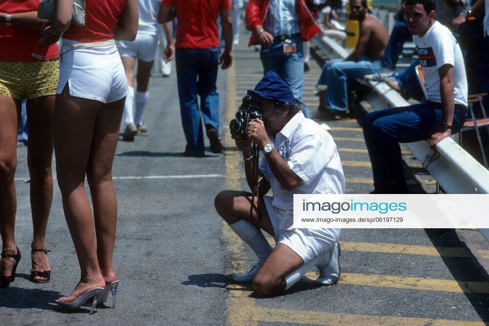 A sports photographer with a medium format camera photographs the beautiful legs of the girls at the South African Grand Prix on 03 January 1980.