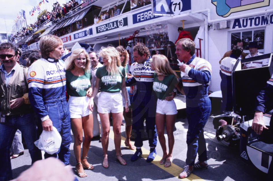 Left to right, drivers Derek Bell, Jochen Mass and Vern Schuppan with the Hawaiian Tropic ladies at the 24 Hours of Le Mans on 19 June 1982.