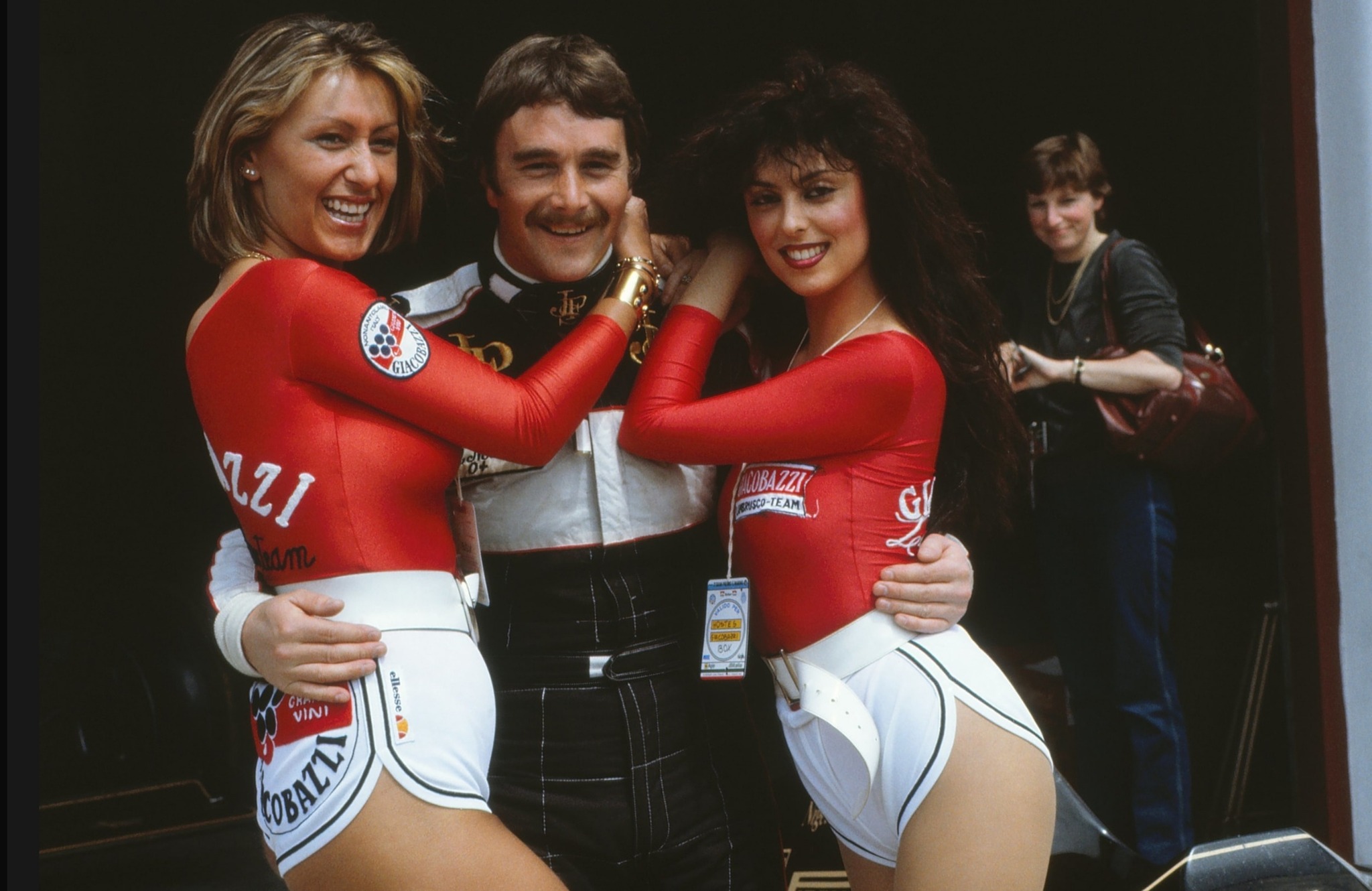 Nigel Mansell with two Giacobazzi Lambrusco girls at Imola on 01 May 1983.