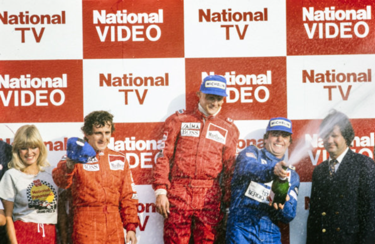 Niki Lauda, McLaren 1st position, Alain Prost, McLaren 2nd position, Derek Warwick, Renault 3rd position, celebrate on the podium at the South African Grand Prix on 07 April 1984.