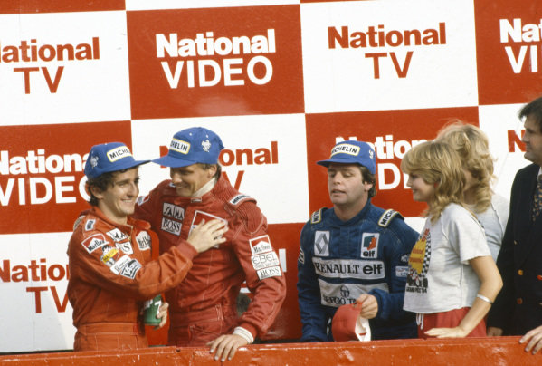 Niki Lauda, McLaren 1st position, Alain Prost, McLaren 2nd position, Derek Warwick, Renault 3rd position, celebrate on the podium at the South African Grand Prix on 07 April 1984.