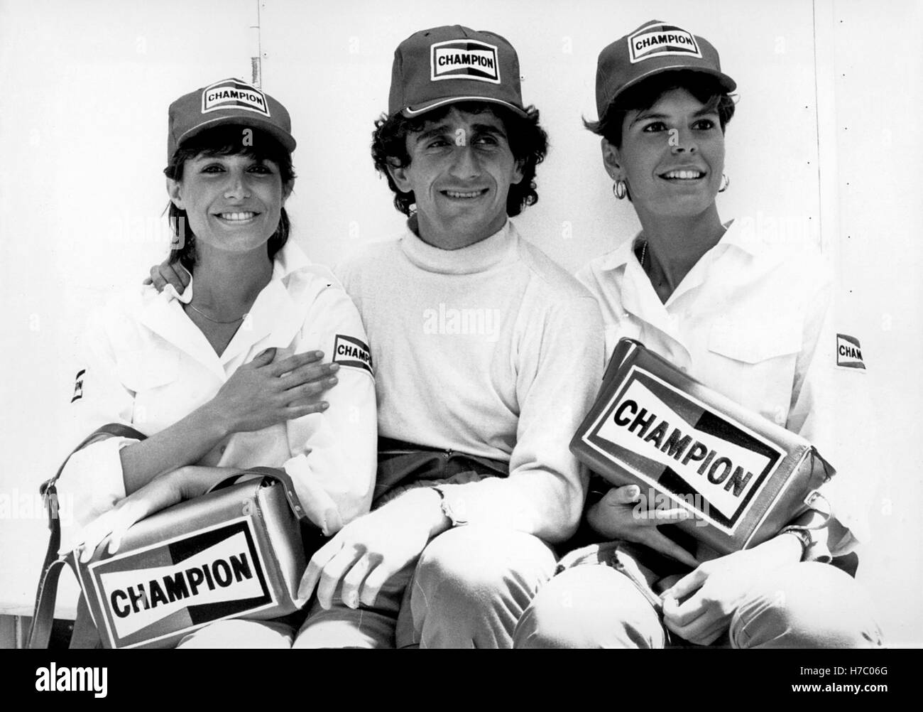 Alain Prost with two Champion promotion girls at the Monaco Grand Prix in Monte Carlo on 19 May 1985.