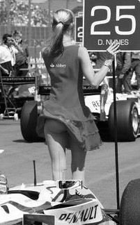 A grid girl in front of a Renault.
