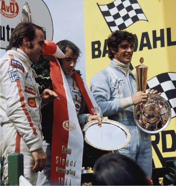 Francois Cevert on the podium with Jackie Stewart and Clay Regazzoni.
