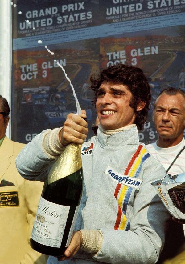 Francois Cevert with a bottle of champagne.