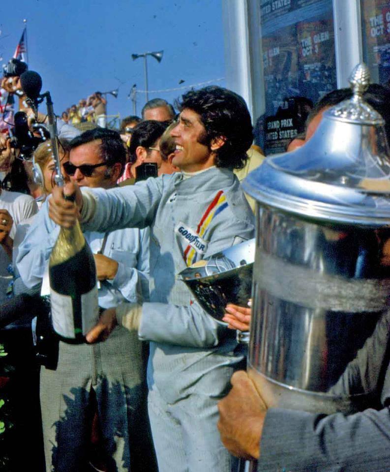 Francois Cevert with a bottle of champagne.