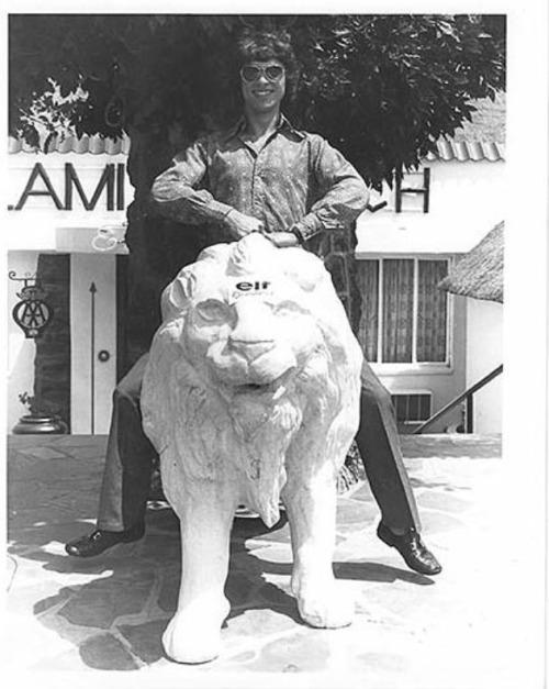 Francois Cevert riding a white lion.
