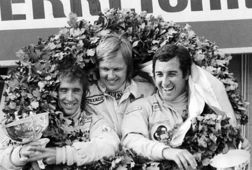 Jackie Stewart, Ronnie Peterson and another driver on the podium.