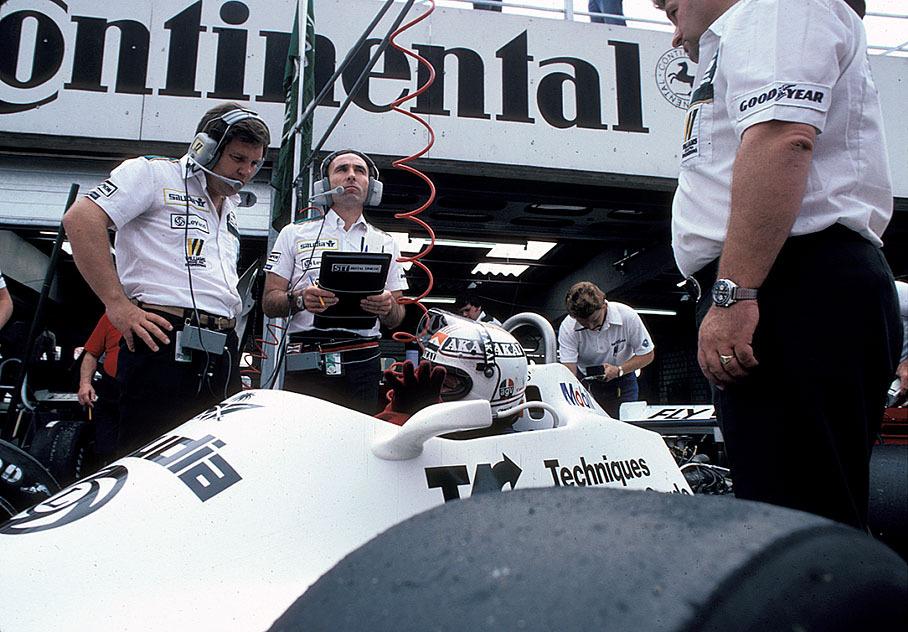 Hockenheim, 1981. At Williams pits team boss Frank Williams and engineer Patrick Head check with Alan Jones in the Williams-Cosworth. 