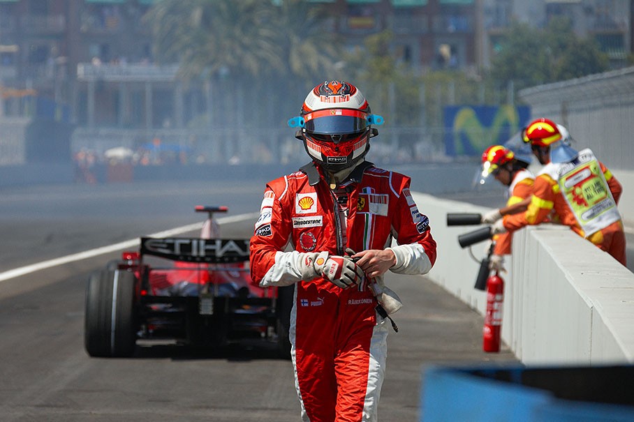 A frustrated Raikkonen walks away from a retired Ferrari car at Valencia in August 2008. 