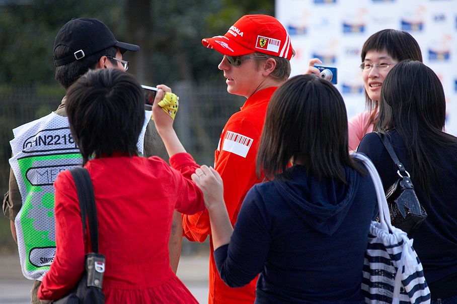 Chinese fans run after reigning World Champion Kimi Raikkonen at Shanghai in October 2008. 