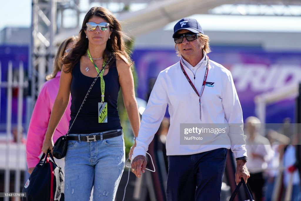 Emerson Fittipaldi with a tall girl.