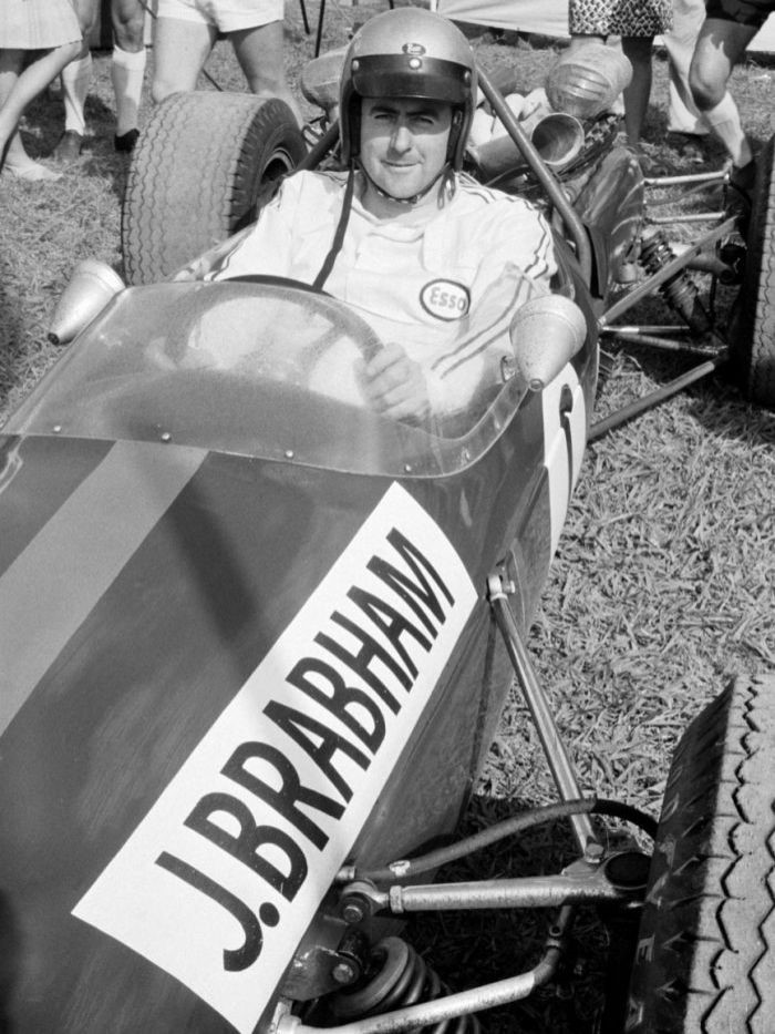 Jack Brabham sits in his car at the Warwick Farm racing circuit near Sydney in 1967.