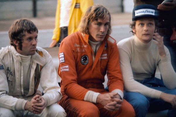 Kyalami, South Africa, on 30 March 1974. Ian Scheckter (Lotus 72D-Ford), James Hunt (Hesketh 308-Ford) and Niki Lauda (Ferrari 312B3) sit in the pit lane during a drivers briefing. 