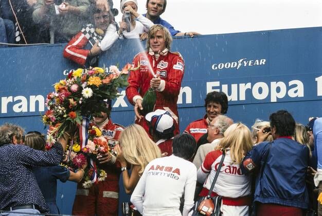 James Hunt celebrates victory on the podium with Clay Regazzoni, 2nd position and Mario Andretti, 3rd position, at the Dutch Grand Prix in Zandvoort on 29 August 1976.