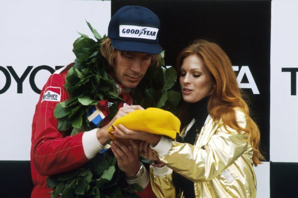Race winner James Hunt, McLaren, signs a hat on the podium for a lucky Penthouse Pet at the US Grand Prix in Watkins Glen on 02 October 1977. 