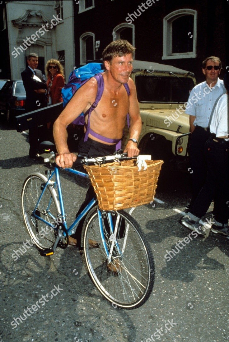 A bare chested James Hunt with bicycle. 