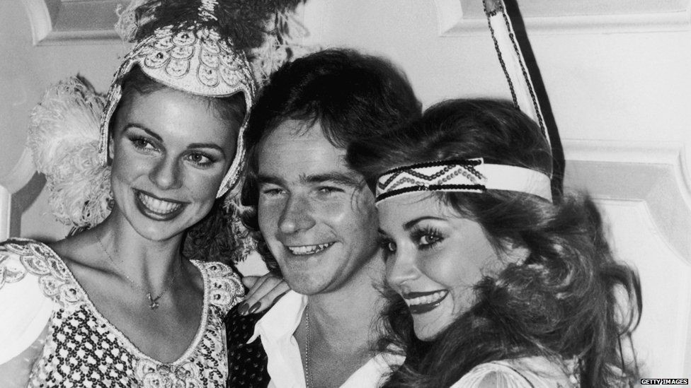 Barry Sheene with two girls.