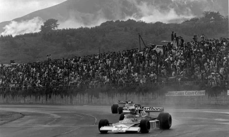 James Hunt drives through the rain in front of Mount Fuji. 
