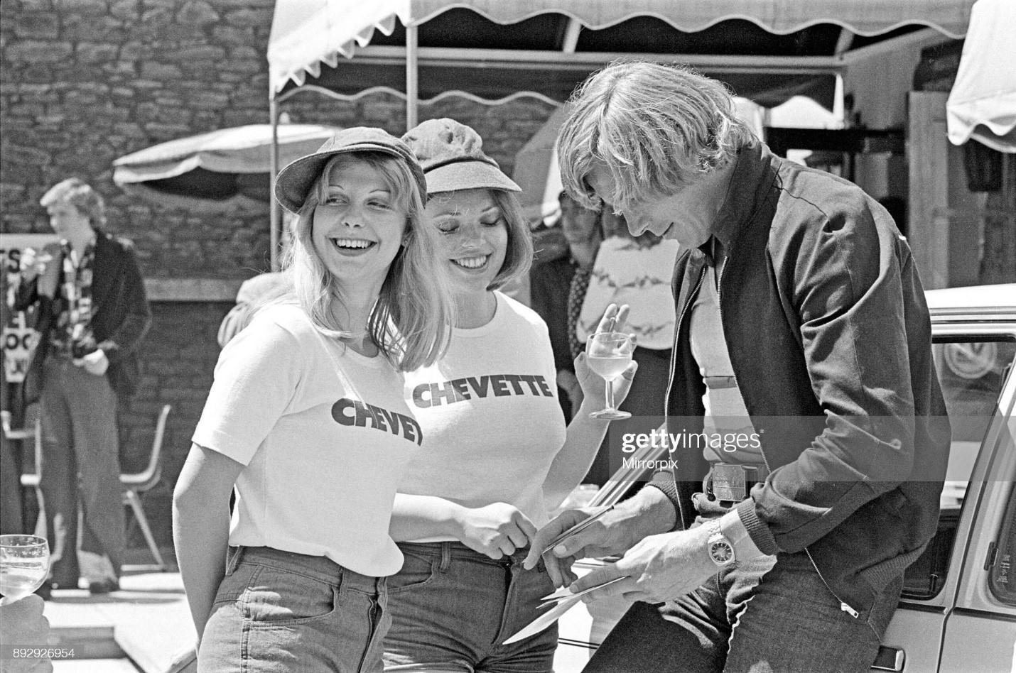 James Hunt signs his autograph for two of his female stewardesses at a Chevette Meet and Greet event. Town and venue unknown. Picture taken circa 1st August 1976. 