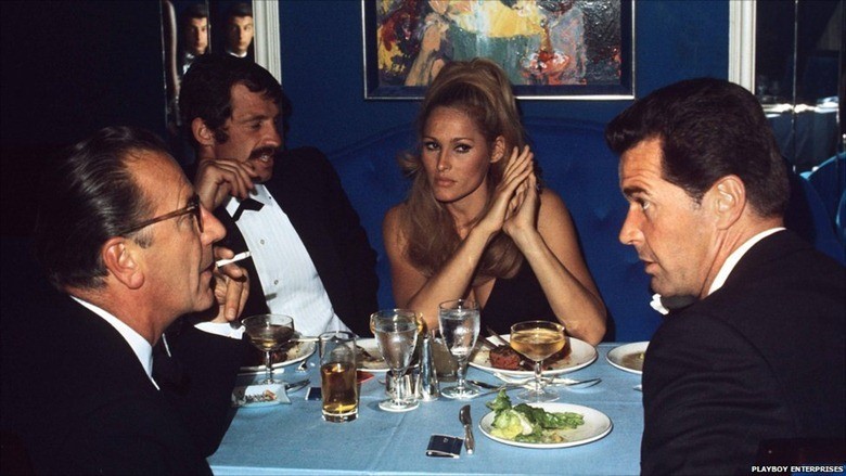 French actor, Jean-Paul Belmondo, Bond girl Ursula Andress and American actor James Garner enjoying a bite to eat at the London Playboy club.