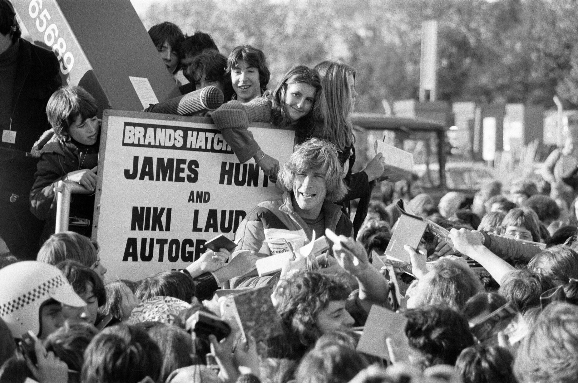 November 08, 1976, Kent, England. James Hunt, the new World Racing Champion, is besieged by thousands of young autograph hunters at Brands Hatch.