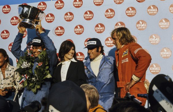 Carlos Reutemann celebrates victory on the podium with Carlos Pace, 2nd position and James Hunt, 3rd position at the US Grand Prix in Watkins Glen on 06 October 1974. 