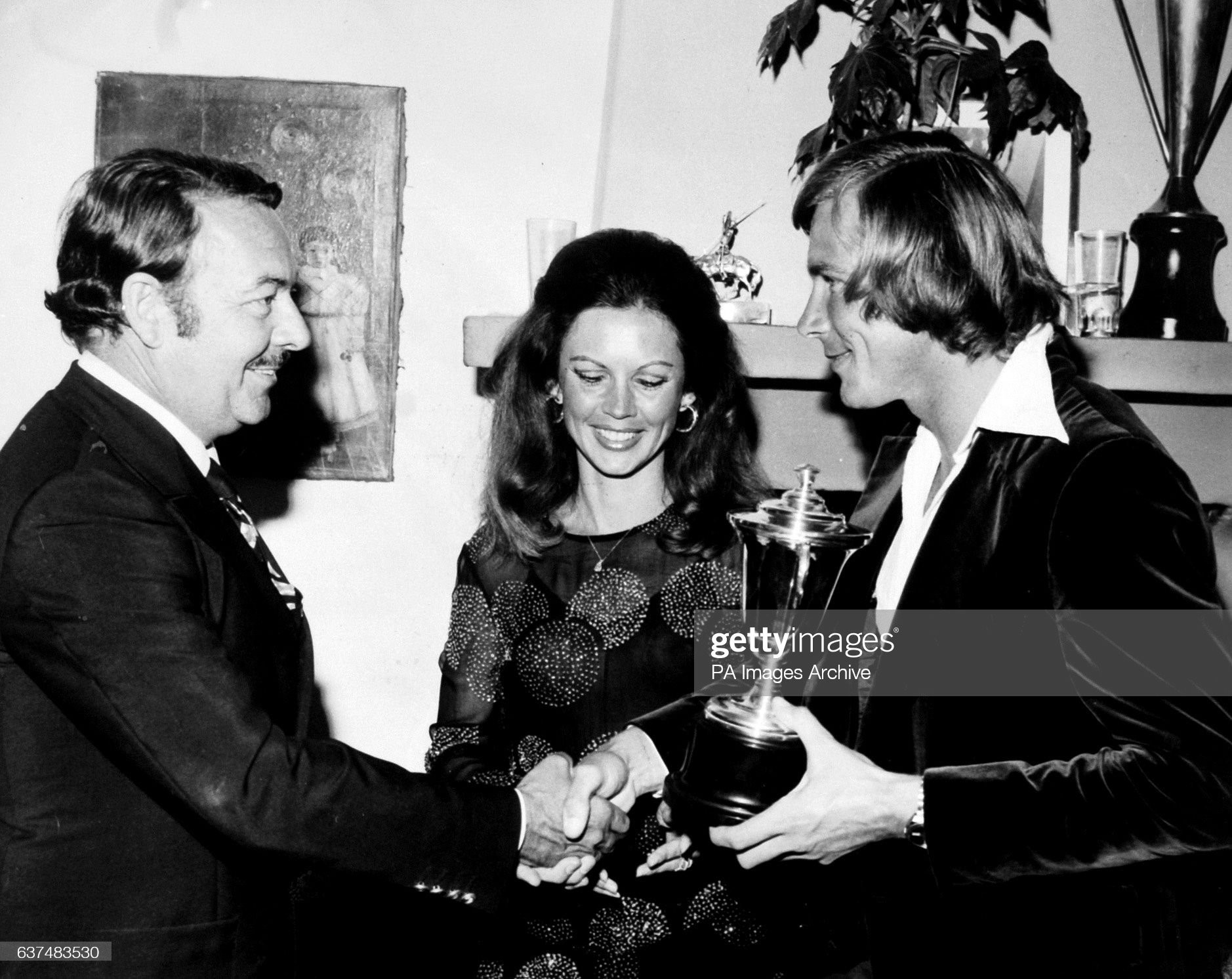 James Hunt at cocktail party at the Marbella Club being presented with a cup by Alfonso and Jackie de Hohenlohe on July 01, 1976. 