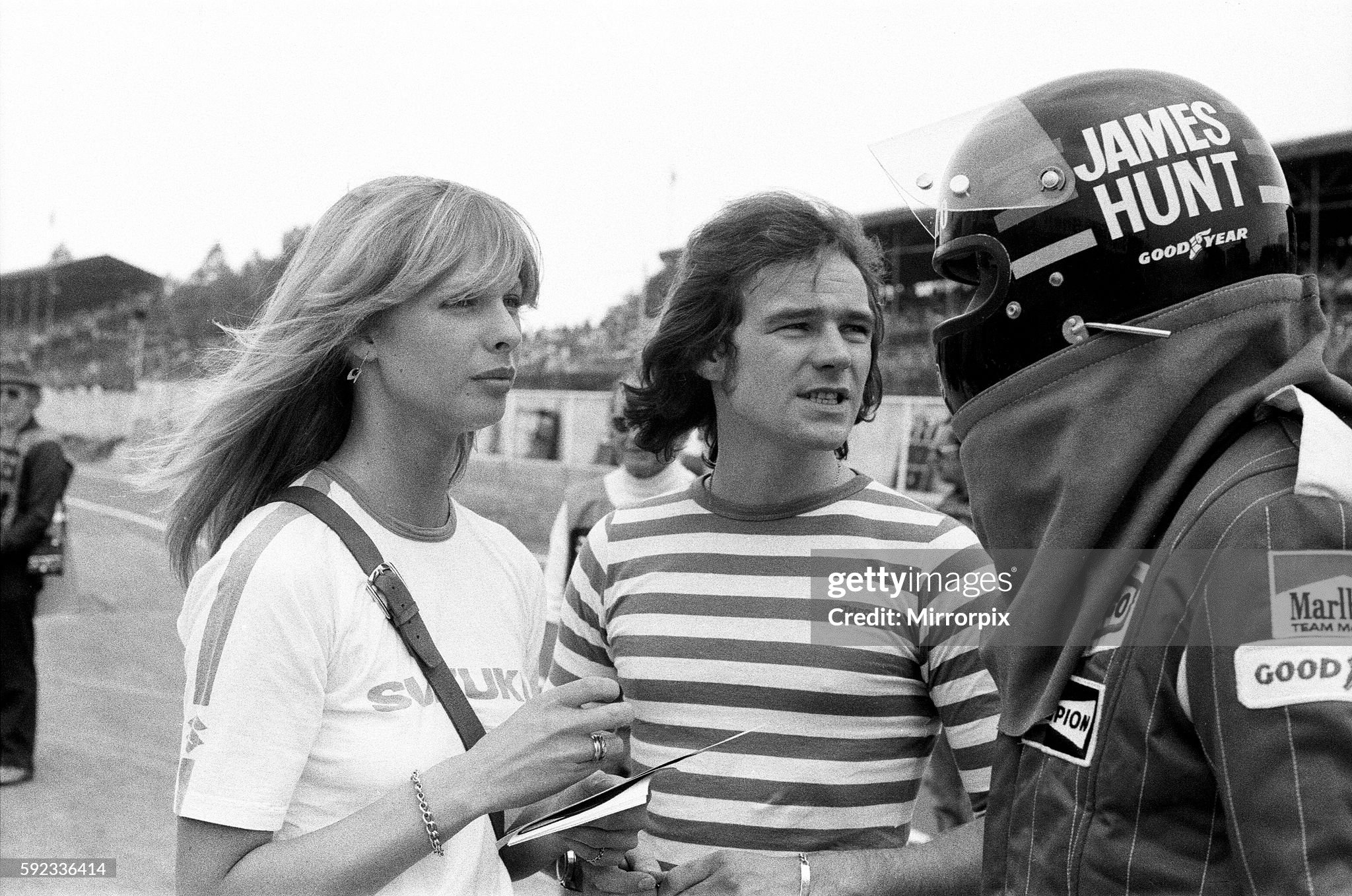 Barry Sheene and his girlfriend Stephanie McLean talking to James Hunt at a practice day for the British Grand Prix held at Brands Hatch, Kent, on 17th July 1976. 