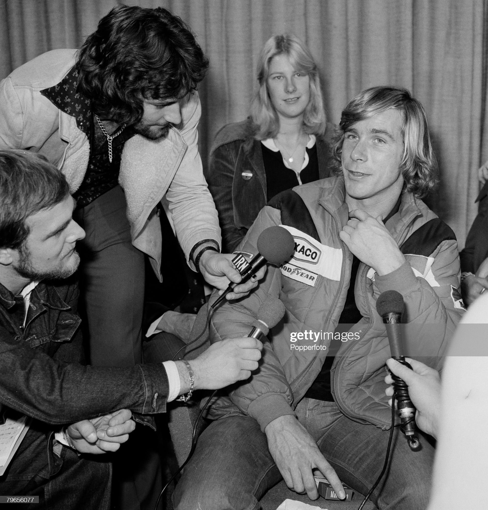 Sport, Motor Racing, London, England, 26th October 1976, Britain's new World Champion James Hunt being interviewed by the press at Heathrow airport after arriving from Tokyo where he won the Formula One World Championship title. 