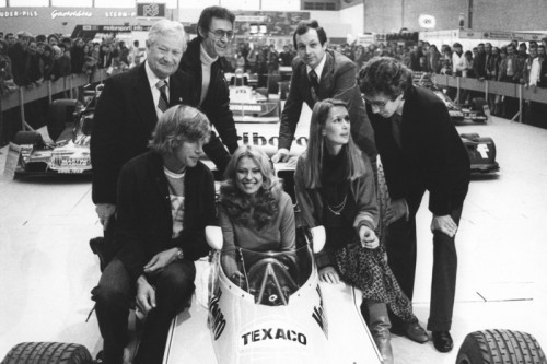 Interesting scene from 1976. James Hunt and Nina Rindt pose for pictures with the McLaren, accompanied by Rolf Stommelen (far left).