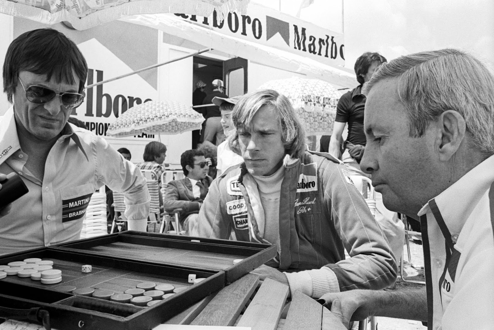 Bernie Ecclestone, Brabham and Teddy Mayer, McLaren, playing backgammon in 1976, James Hunt watching the game.