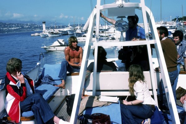 Reigning World Champion James Hunt, McLaren, entertains guests on a boat at Monaco on 22 May 1977.