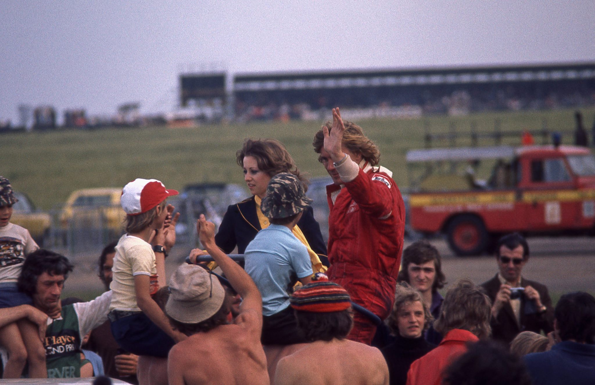 James Hunt waves to the crowd after driving the McLaren M26 Ford V8 to win the 1977 British Grand Prix at Silverstone.