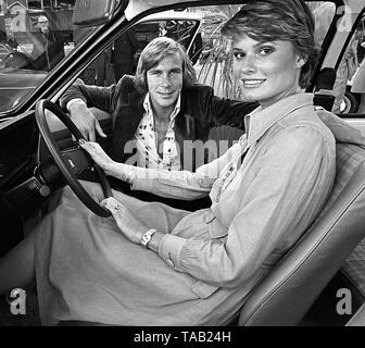 Portsmouth, England, 1975. James Hunt and his wife Suzy visiting the United Services garage to review the UK’s first electric car. 