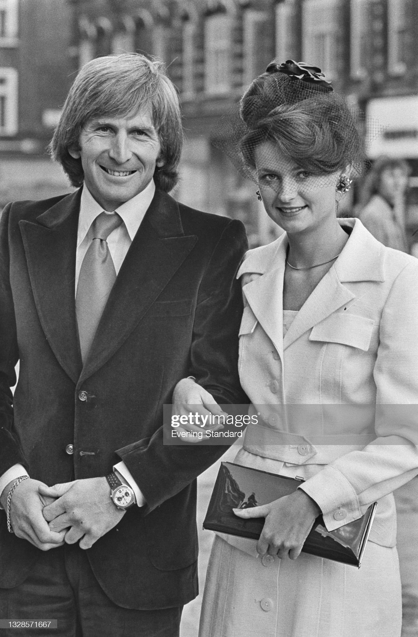 British racing driver Derek Bell and his wife Pam attend the wedding of British racing driver James Hunt and model Suzy Miller at Brompton Oratory in London, UK, 18th October 1974.