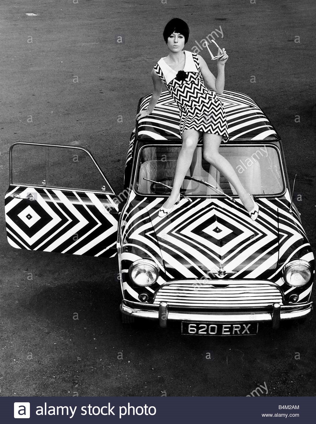 A girl on the Mini that has received the op art treatment in March 1966..